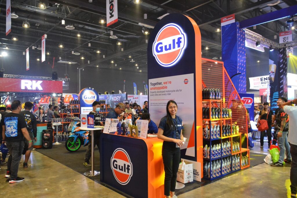 Gulf Gas Station trade show booth with booth host smiling. 