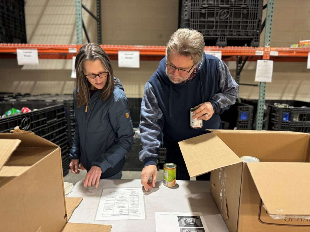 Cathy and Tommy packing food boxes at SBM